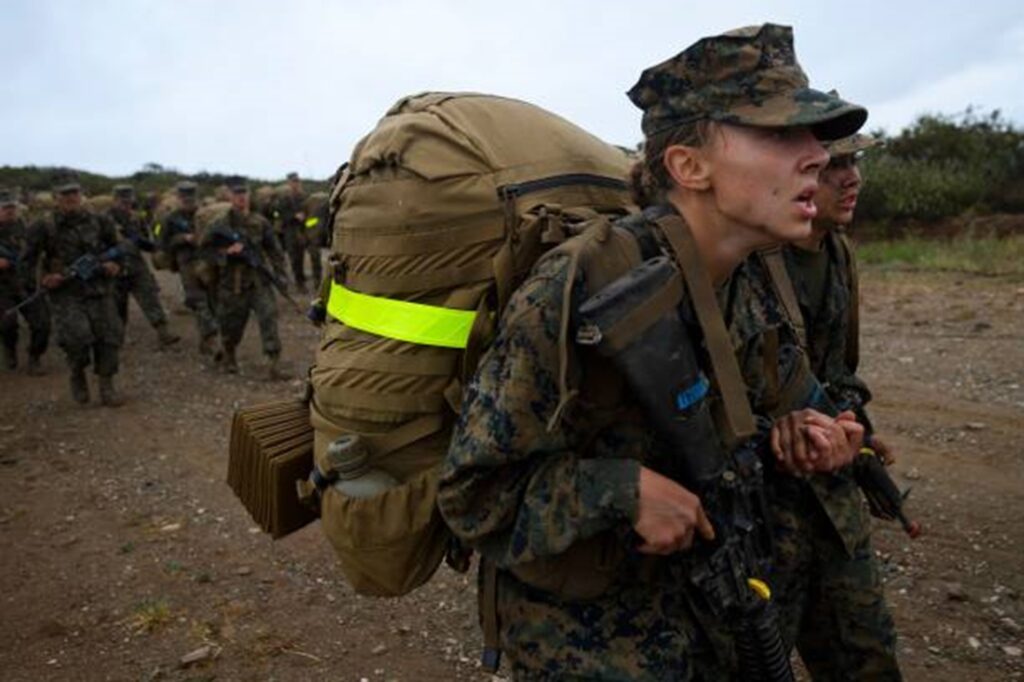 Marching Marines fully loaded with packs and weapons